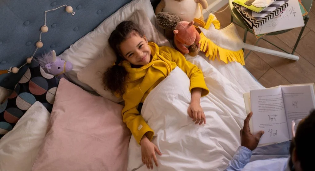 Parent and child using a familiar comfort item while preparing for change