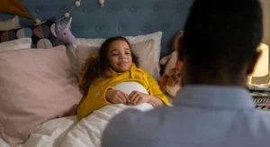 parent guiding child at bedtime