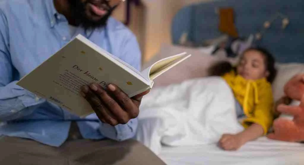 Parent turning down a child’s bed ahead of bedtime at home