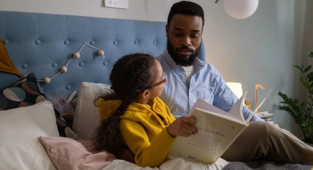 Parent listening while a child explains one part of a story after reading