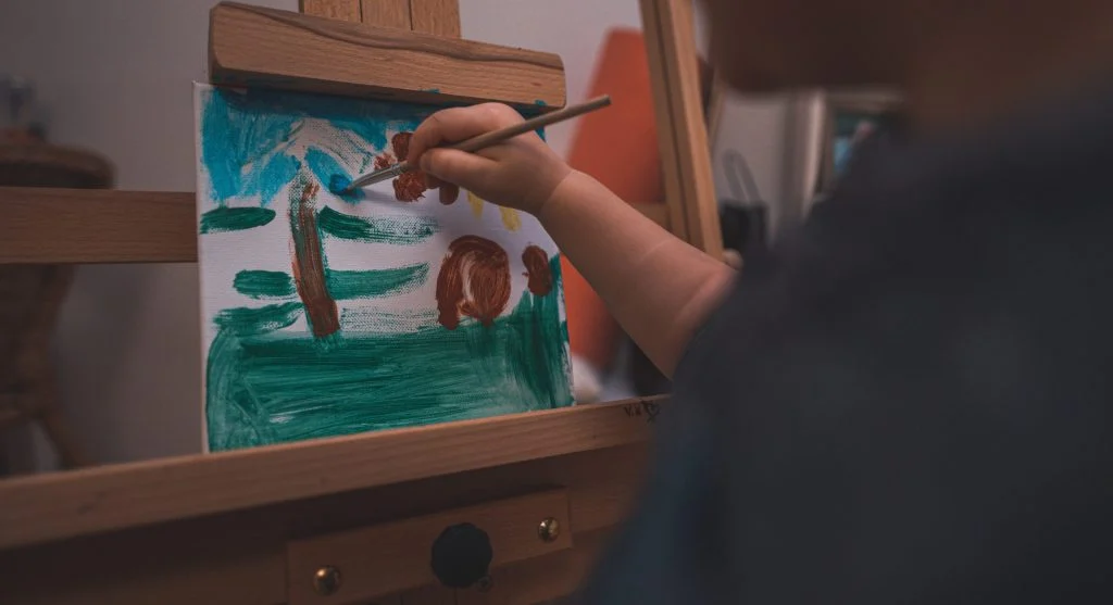 Child upset over a small mistake during a creative activity at home
