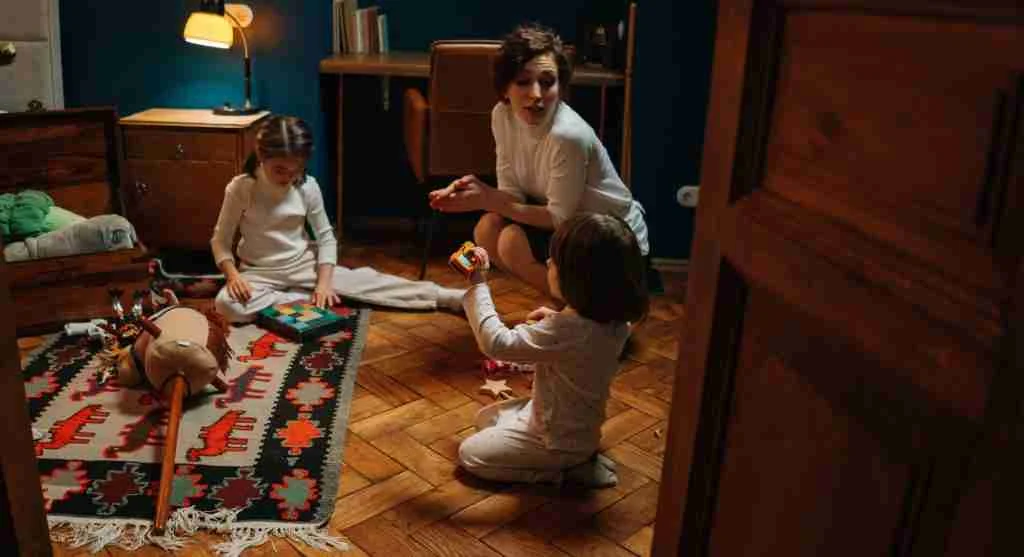 Adult guiding children through the next step after an apology at home