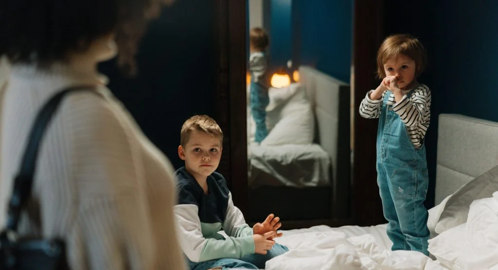 Child noticing a sibling breaking a rule during family life at home