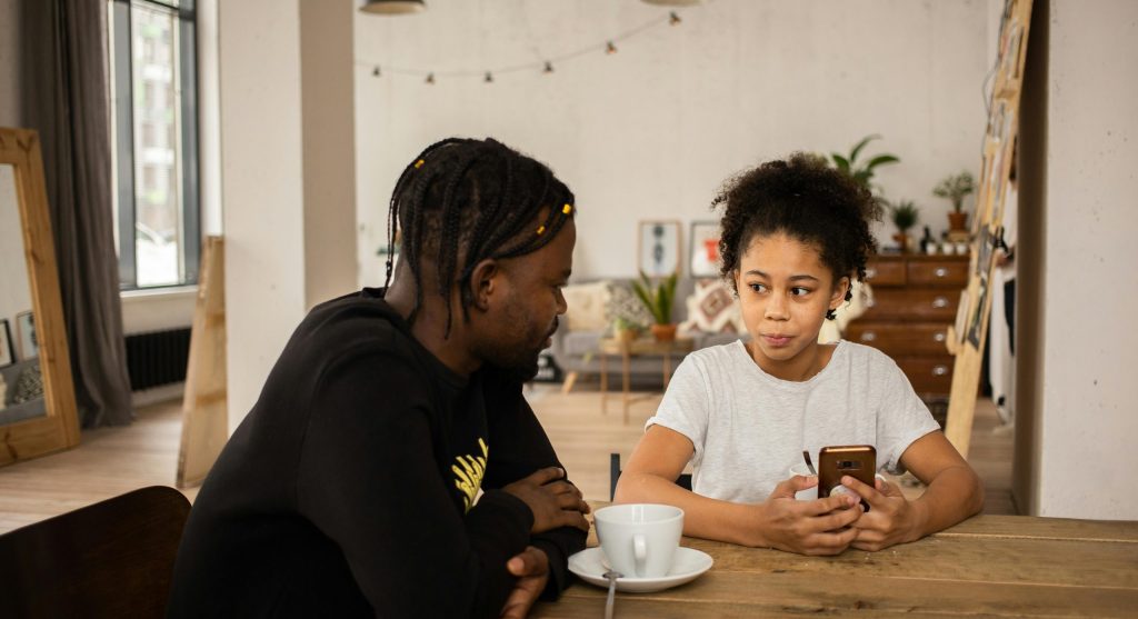 Parent helping a child name feelings during a calm home conversation