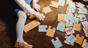 Parent helping a child match uppercase and lowercase letters at home