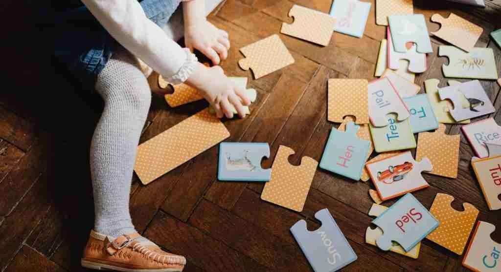 Parent helping a child match uppercase and lowercase letters at home