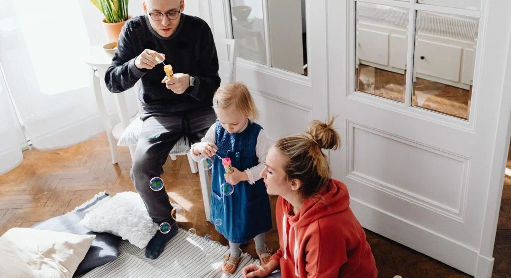 Parent listening patiently while a child slowly begins talking at home