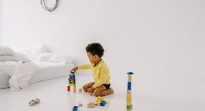 kid playing with colorful blocks