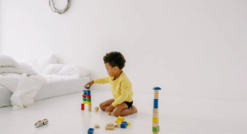 kid playing with colorful blocks Playing