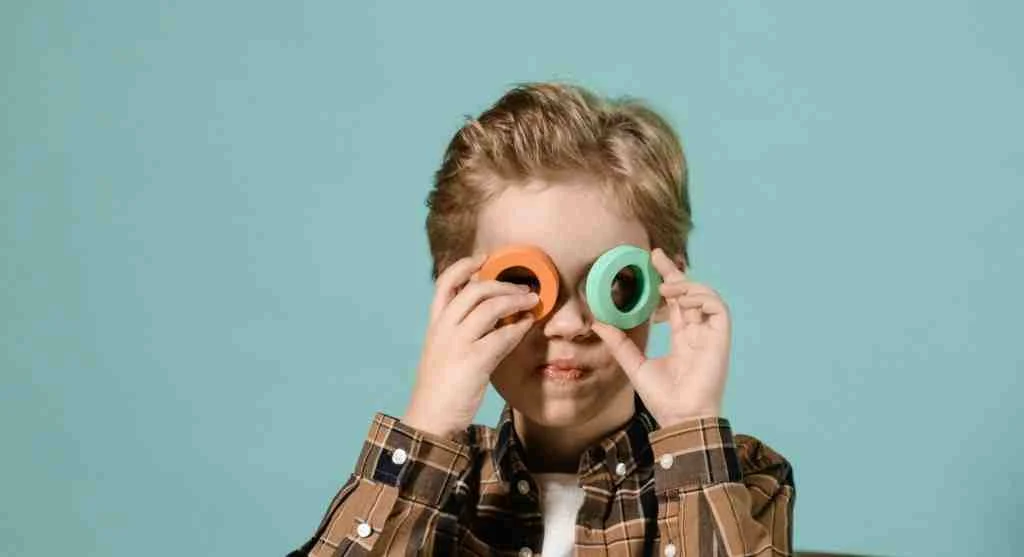 Child glancing between a model letter above the line and the writing space below
