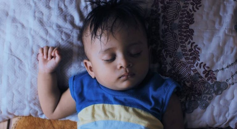 sleepy child in bed at night