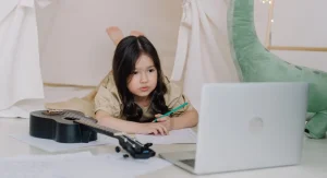 Child saying a sentence aloud before writing during home learning time