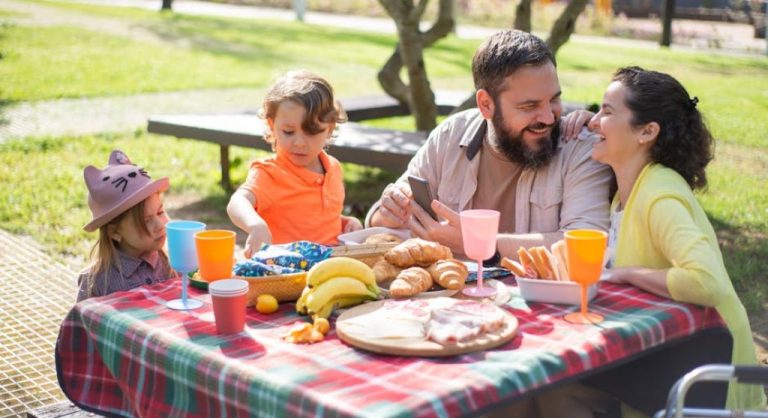 happy family having picnic outdoors