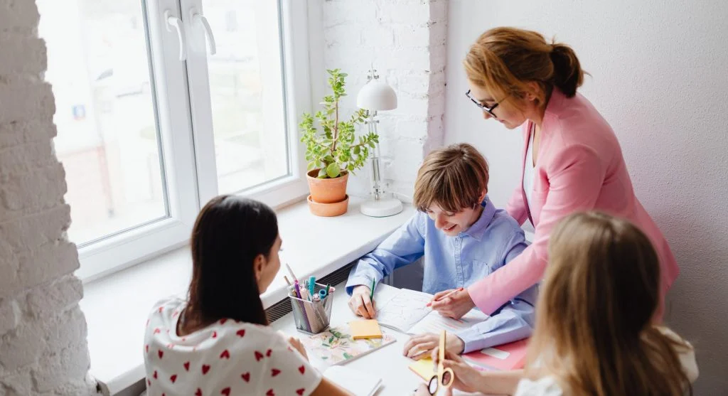 Parent teaching a child how to respond to one worksheet example at home
