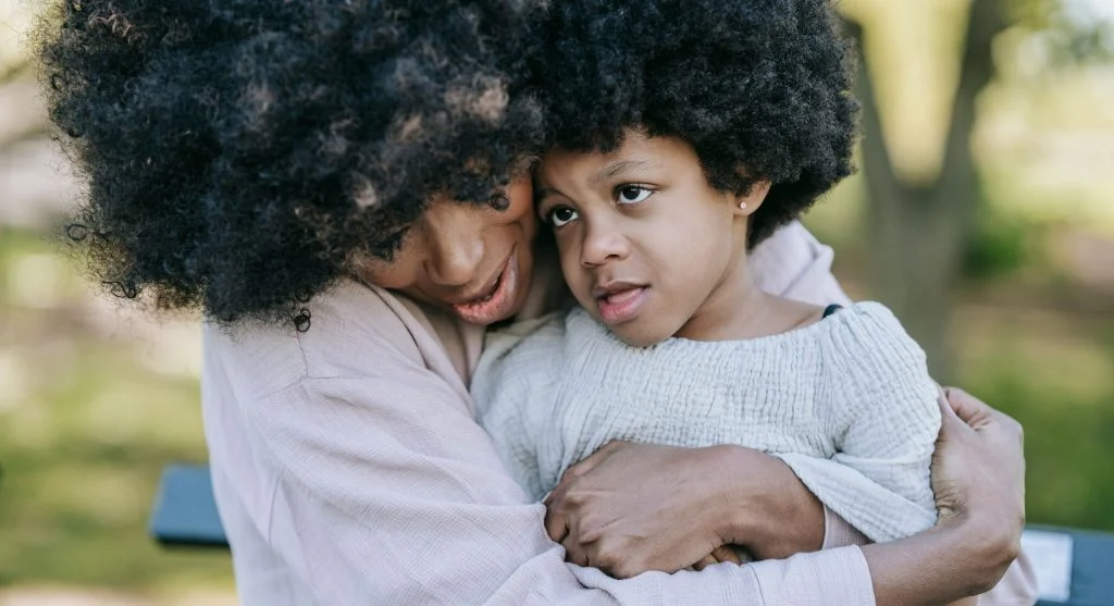 Child calming down with a parent after a social mistake