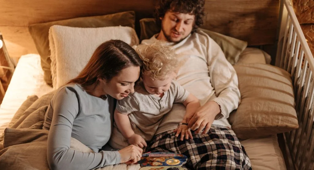Parent and child sharing a familiar evening tradition together before bed