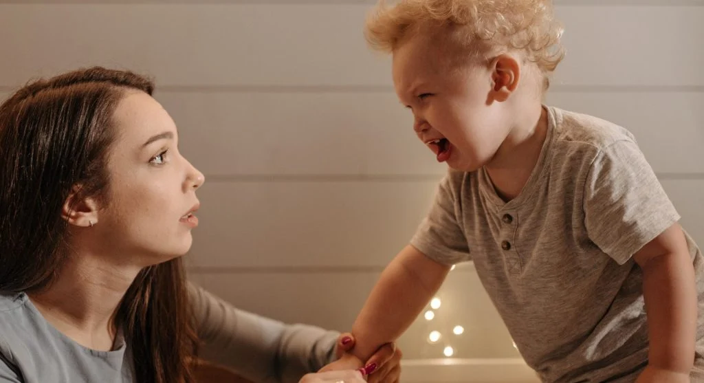 Parent helping a child name a difficult feeling during frustration