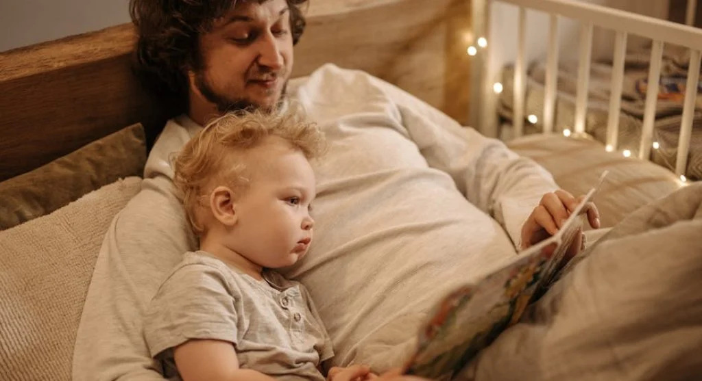 kid reading book at bedtime