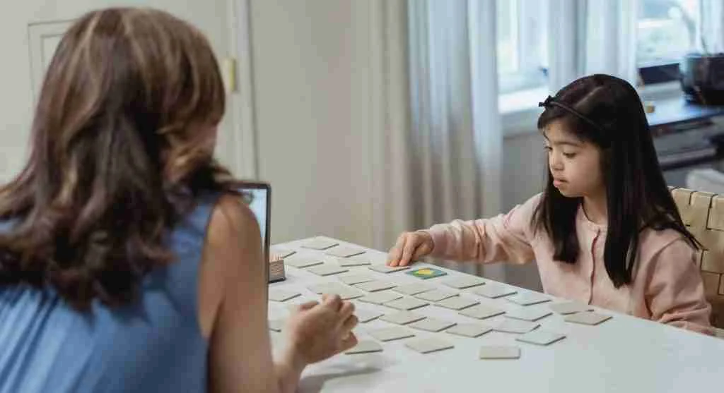 Parent repeating a beginning sound while a child looks at a row of picture cards