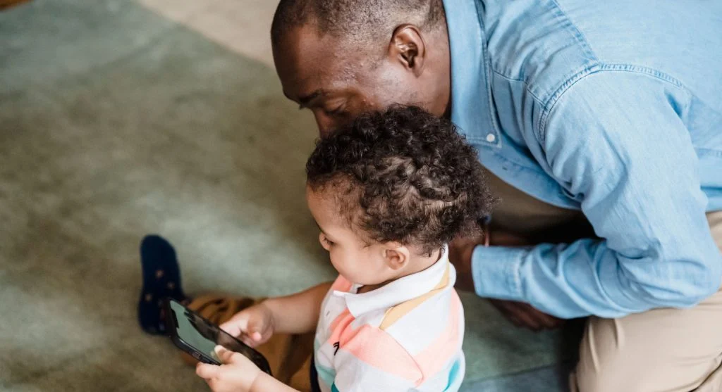 Parent helping a child move into the next routine after placing a device away