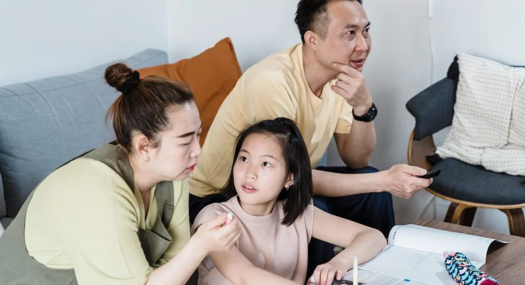 Parent redirecting a child with a clear next-step instruction at home