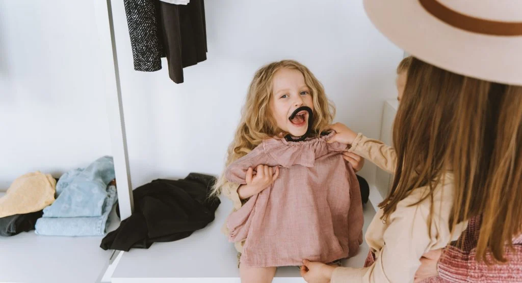 Child starting to get dressed after the first item is prepared in advance