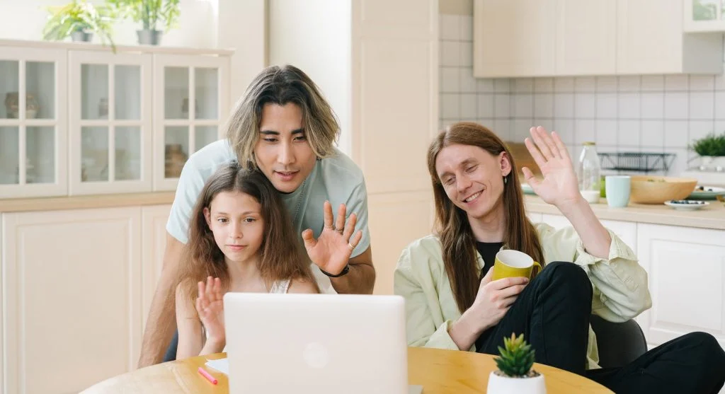Parent helping a child through a familiar video call goodbye ritual