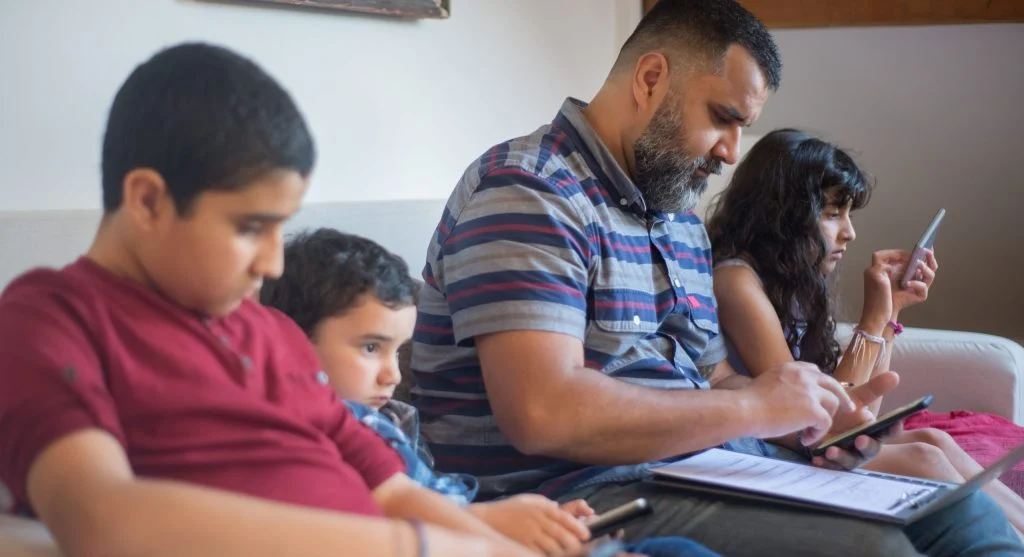 Parent using a visual cue near a charging spot before screen time ends