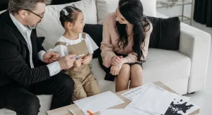 Parent calmly talking with a child after a small social mistake at home