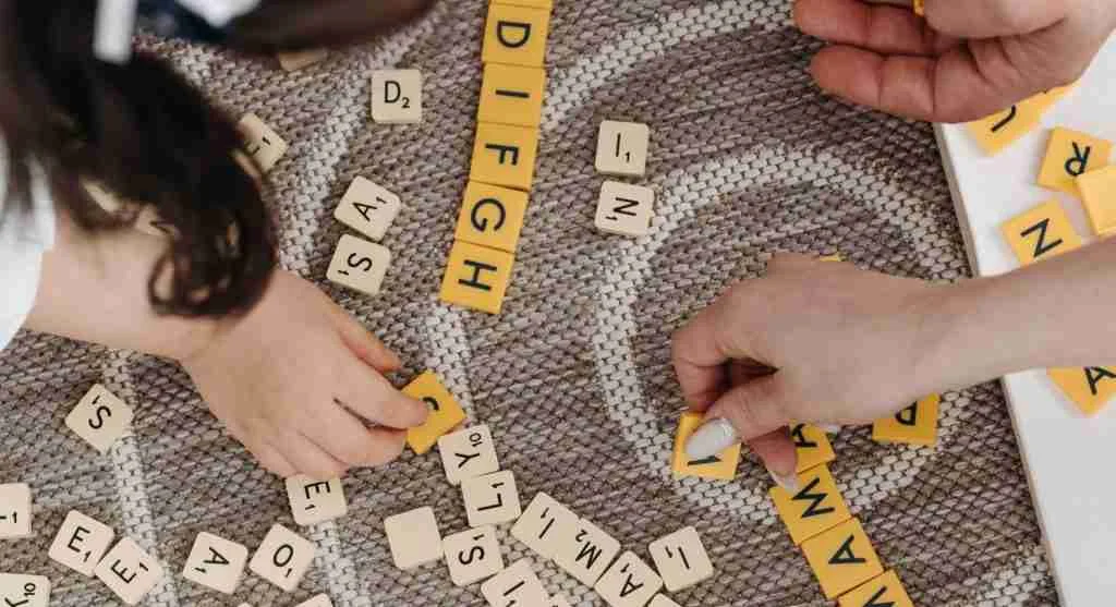 Parent guiding a child to compare one uppercase letter with one lowercase letter