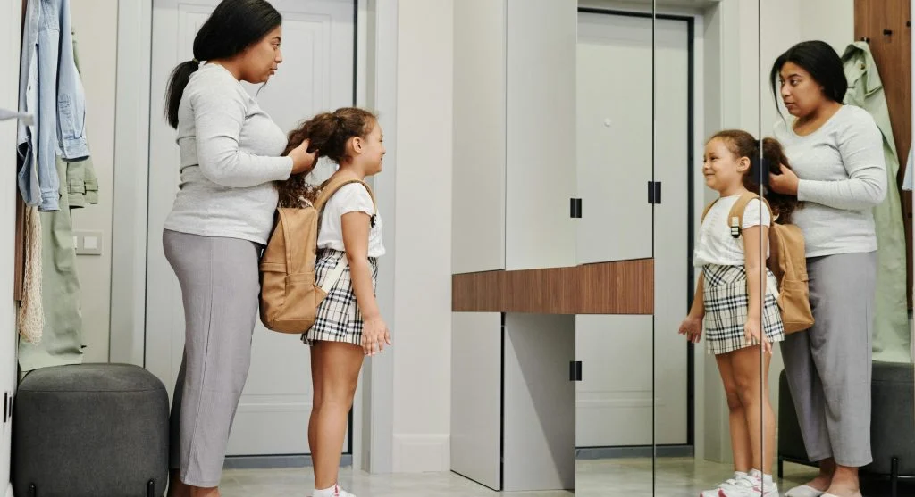 parent child preparing backpack together
