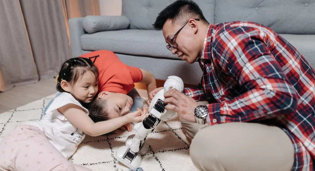 Parent helping children solve a fairness disagreement during play