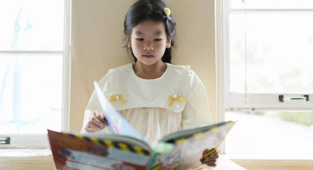 kid reading book with curiosity