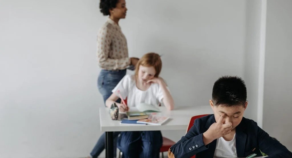 Child noticing a mistake in schoolwork and feeling frustrated at home
