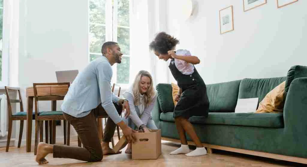 Parent opening a familiar family tradition box while a child watches eagerly