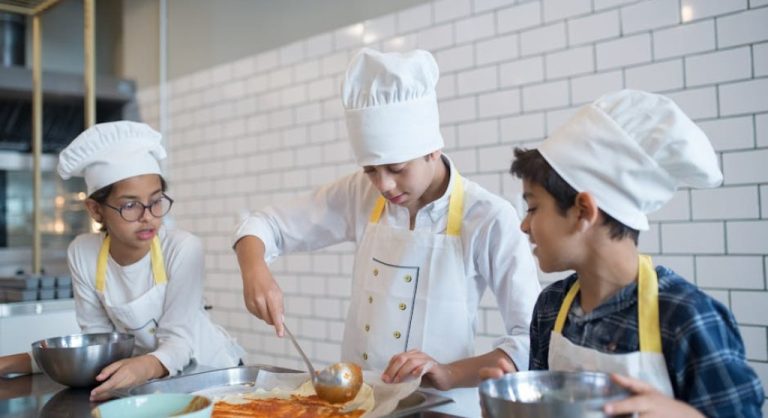 kid learning to cook in kitchen
