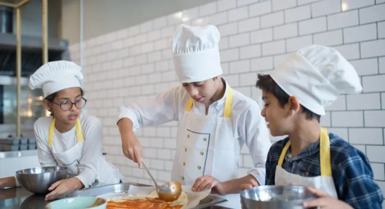 kid learning to cook in kitchen