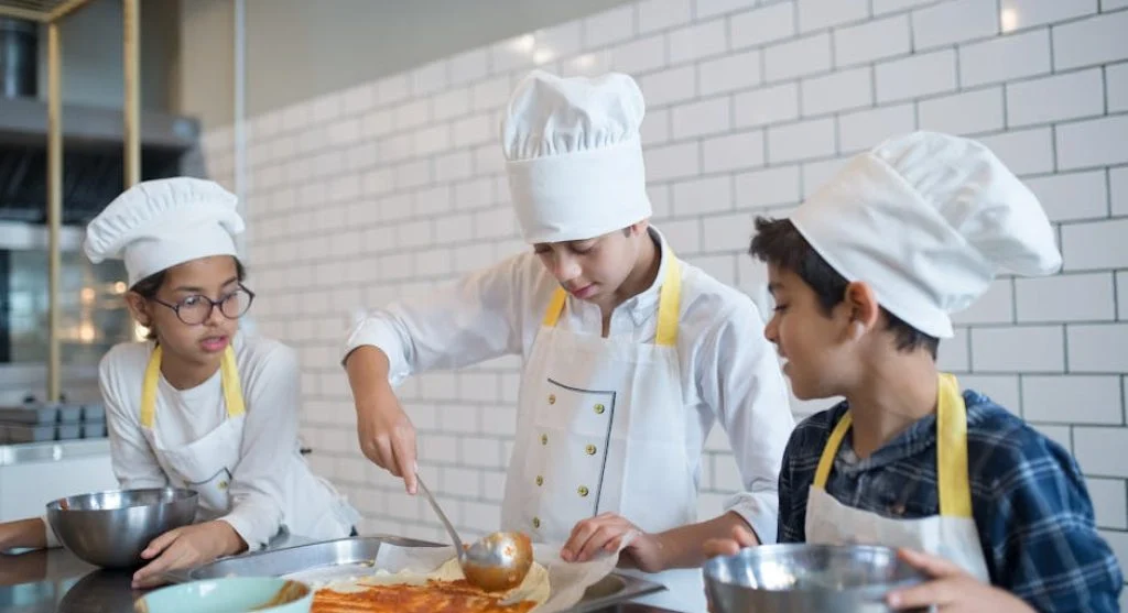 kid learning to cook in kitchen