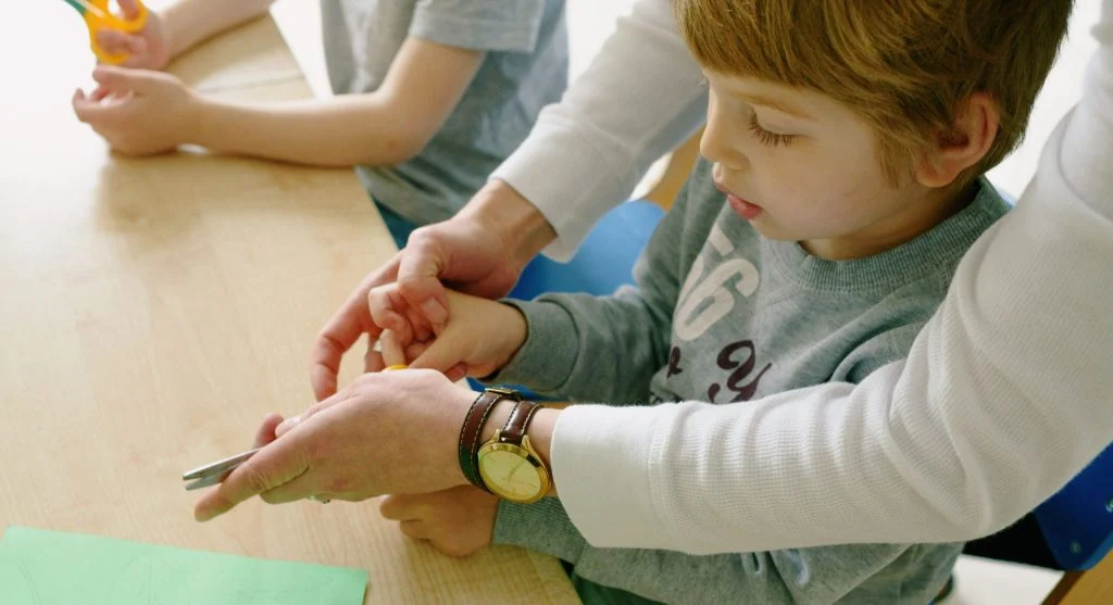 Parent calmly encouraging a child to try again after a small mistake