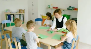 Parent giving a child one craft supply at a time during home learning