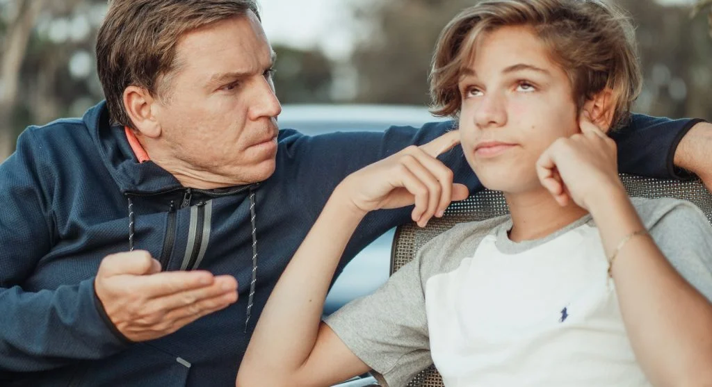 Parent speaking quietly and firmly during a correction with a child