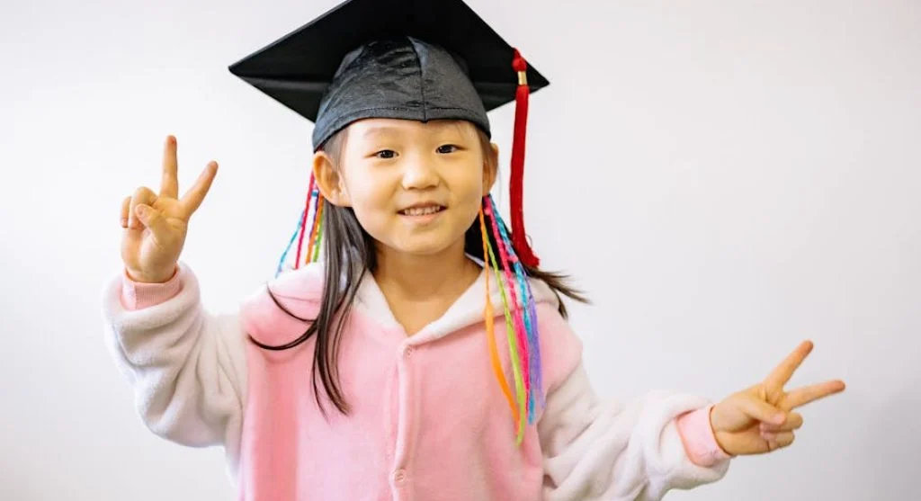 smiling child with achievement certificate