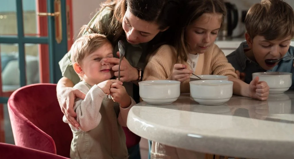 Parent guiding a child through a familiar screen-free morning routine
