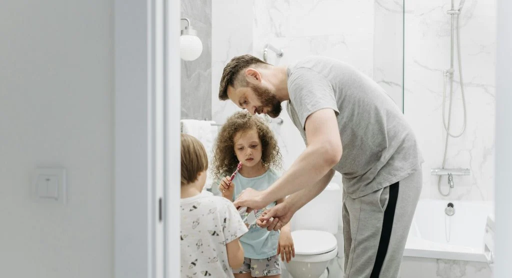 parent guiding child through morning routine
