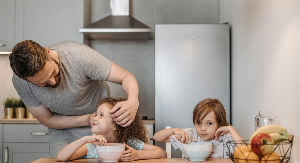 Child responding to a calm early rule reminder from a parent at home