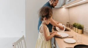 Child doing a familiar small job during a repeated family tradition at home