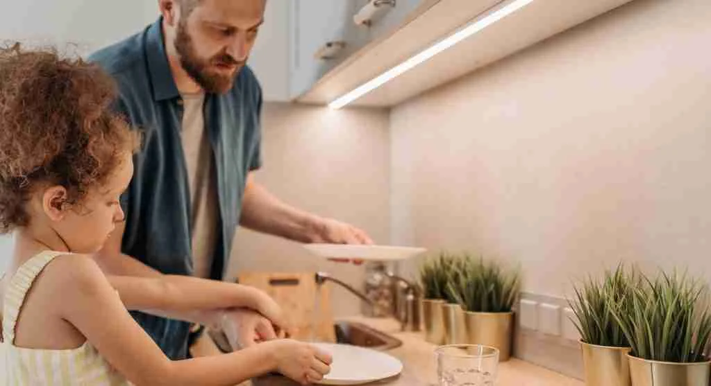 Child helping start a family tradition by doing a small repeated task