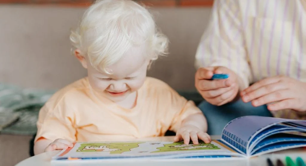 smiling kid reading book