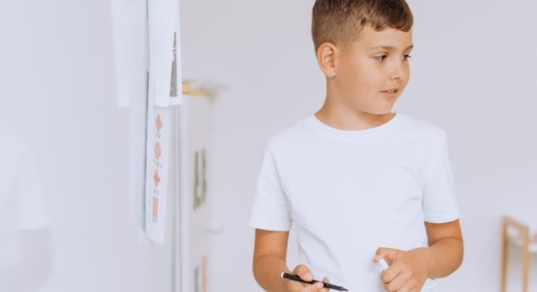 kid listening to teacher in classroom