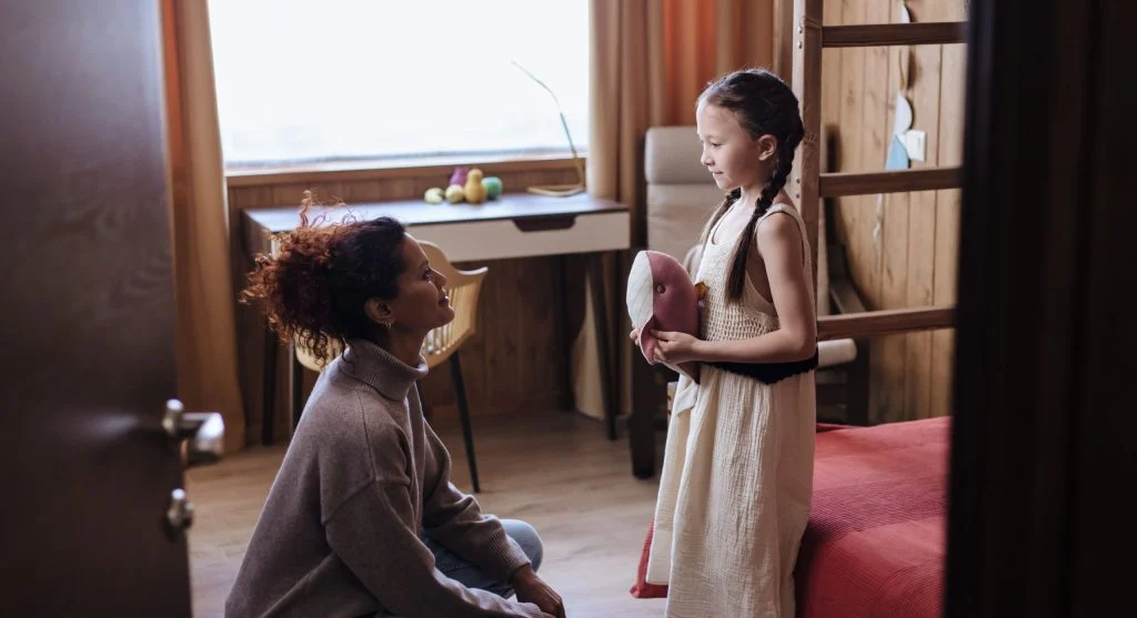 Child carefully correcting an adult during a home conversation
